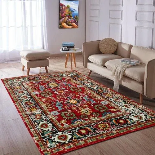 A Persian rug with a red background and intricate floral patterns