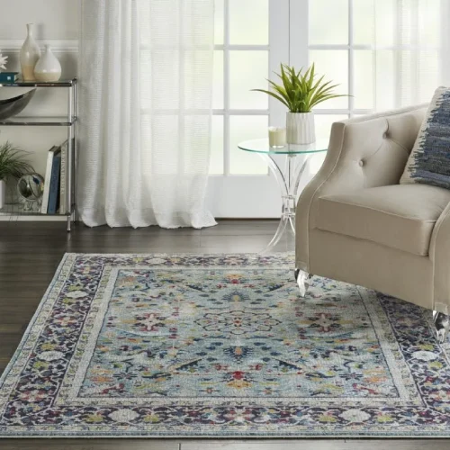 A blue and beige oriental rug with a floral pattern, placed in a living room