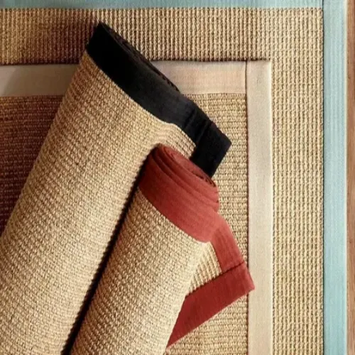 A close-up of rolled sisal rugs with contrasting borders