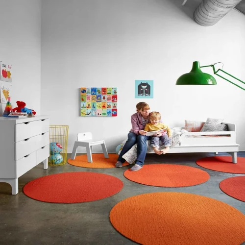 A colorful, geometric round rug with a Persian design