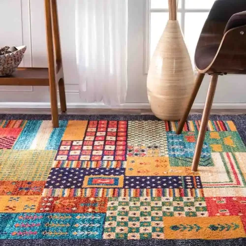 A colorful patchwork rug with geometric and floral patterns