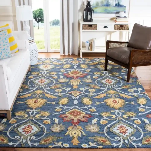 A floral, traditional wool rugs in shades of blue, yellow, and red, placed in a coastal-inspired living room