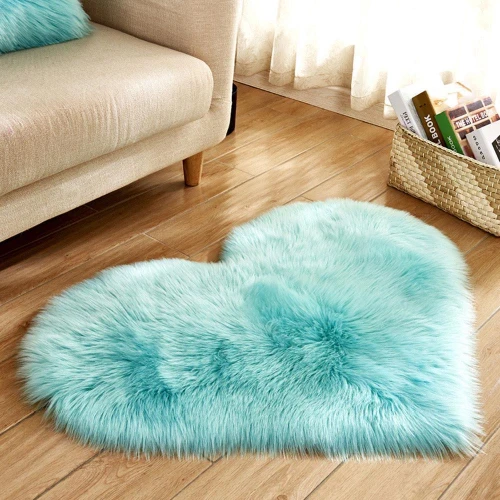 A heart-shaped, fluffy turquoise rug on a wooden floor in a living room