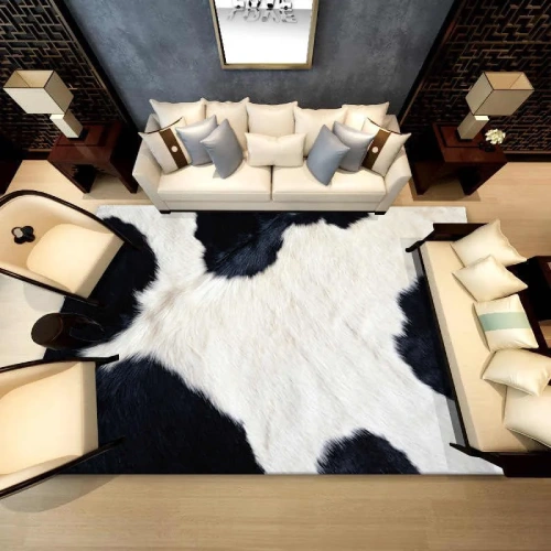 A large, black and white cowhide rug is placed in the center of a modern living room