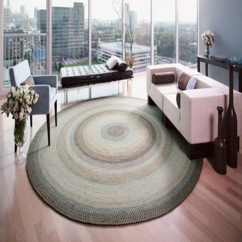 A large, round braided rug in neutral tones, featuring a circular pattern