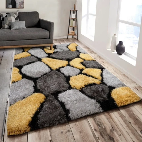 A large, shaggy rug with a pebble-shaped pattern in shades of yellow, gray, and black, placed in a modern living room