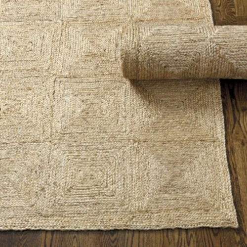 A partially rolled-up jute rugs with a square pattern