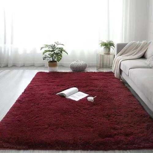 A plush, deep burgundy wool rug in a modern living room in Dubai