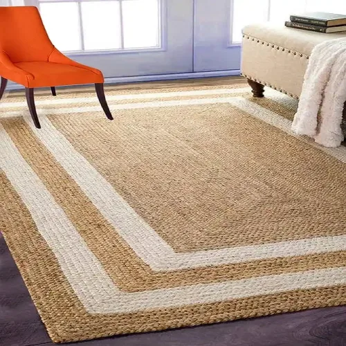 A rectangular jute rug with a white border framing the natural jute center