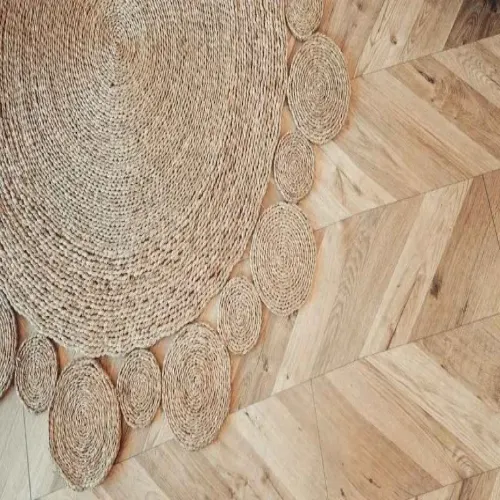 A round sisal rug with a unique design featuring smaller circular elements around the edge