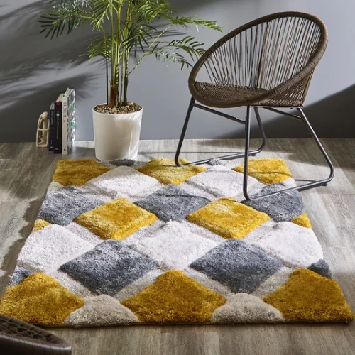 A shaggy, geometric rug in yellow, gray, and white, placed under a wicker chair in a modern living room