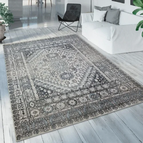 A vintage-inspired oriental rug in shades of gray, blue, and cream