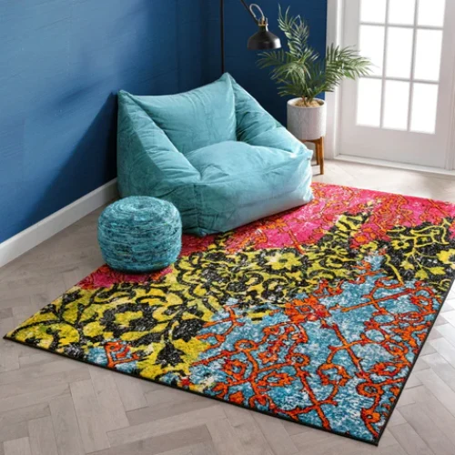 Bold patchwork rug in vibrant colors like red, yellow, and blue, featuring floral and damask patterns