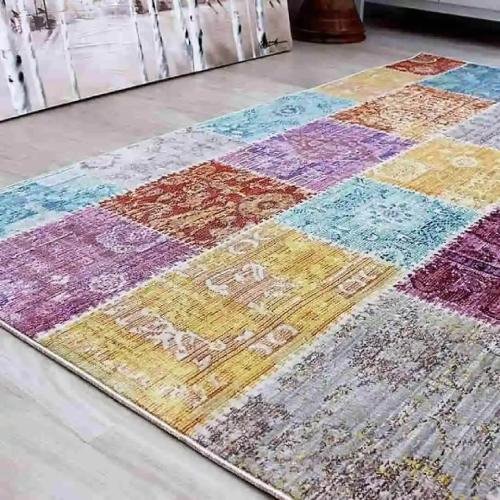 Colorful patchwork rug with vibrant shades of purple, blue, yellow, and red, perfect for adding