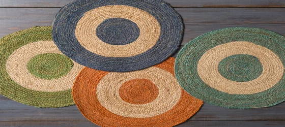 Four round jute rugs with concentric circles of different colors, including green, blue, orange, and teal