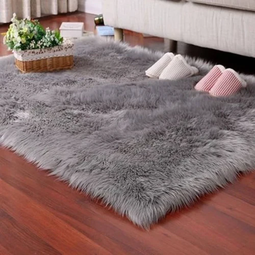 Luxury shaggy gray rug on a wooden floor.