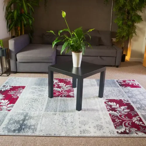 Patchwork rug in Dubai living room with a small black side table and a large potted plant