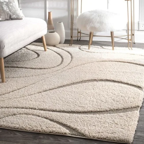 The shaggy rugs is placed in a modern living room setting and appears soft and plush