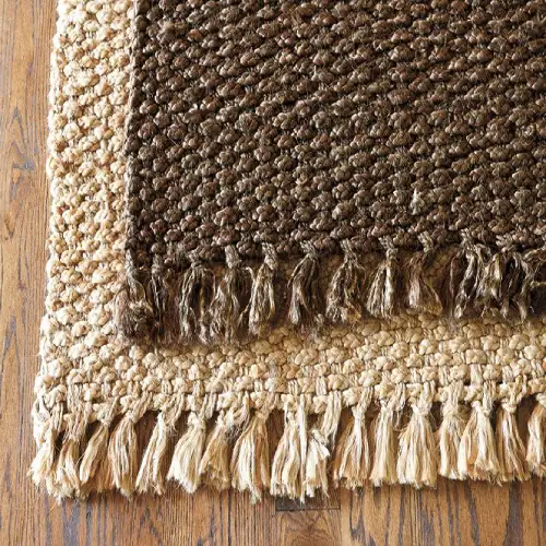 Two rectangular jute rugs stacked on top of each other