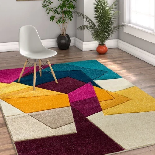 colorful geometric area rug with shades of teal, yellow, pink, and cream