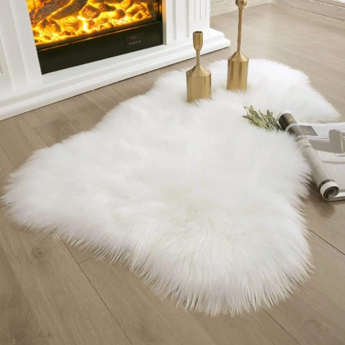 white shaggy rug placed in front of a fireplace on a wooden floor