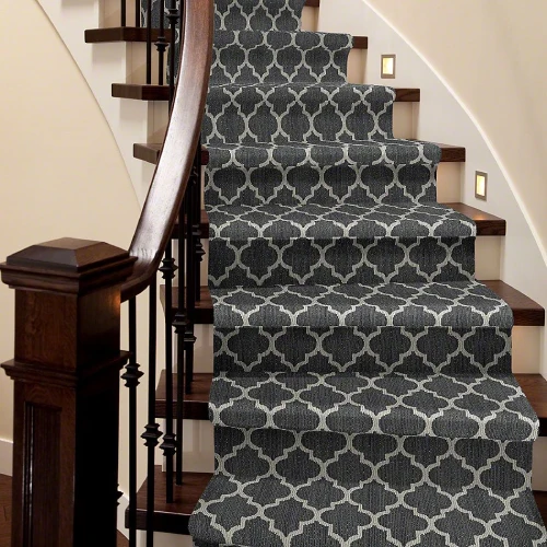 A dark gray stair carpet with a geometric trellis pattern