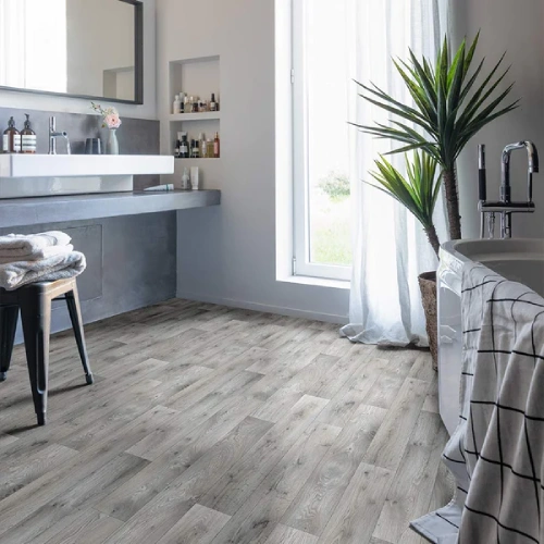 A modern bathroom with light gray vinyl carpet