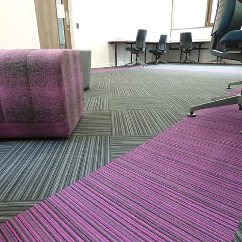 A modern office space in Dubai featuring a stylish striped carpet in shades