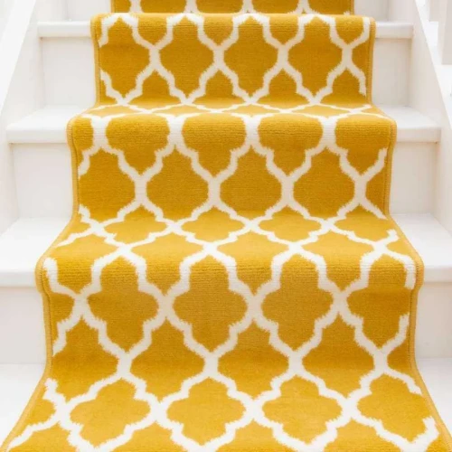 A yellow trellis-patterned stair carpet runner is installed