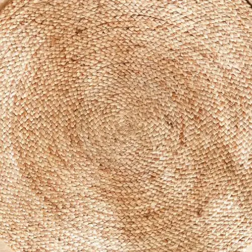 A circular jute rug, showcasing the organic beauty of its natural fibers