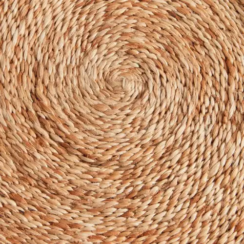 A round jute rug with a tightly woven, spiral pattern