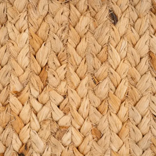 Close-up of a woven jute rug with a braided pattern.