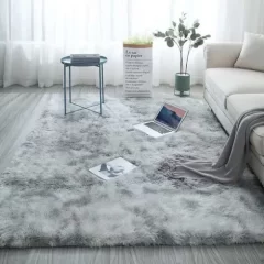 A large, shaggy rug in a light gray color with darker gray accents