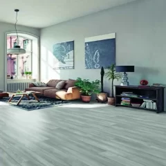 Modern living room with gray vinyl flooring. A brown leather sofa, a coffee table